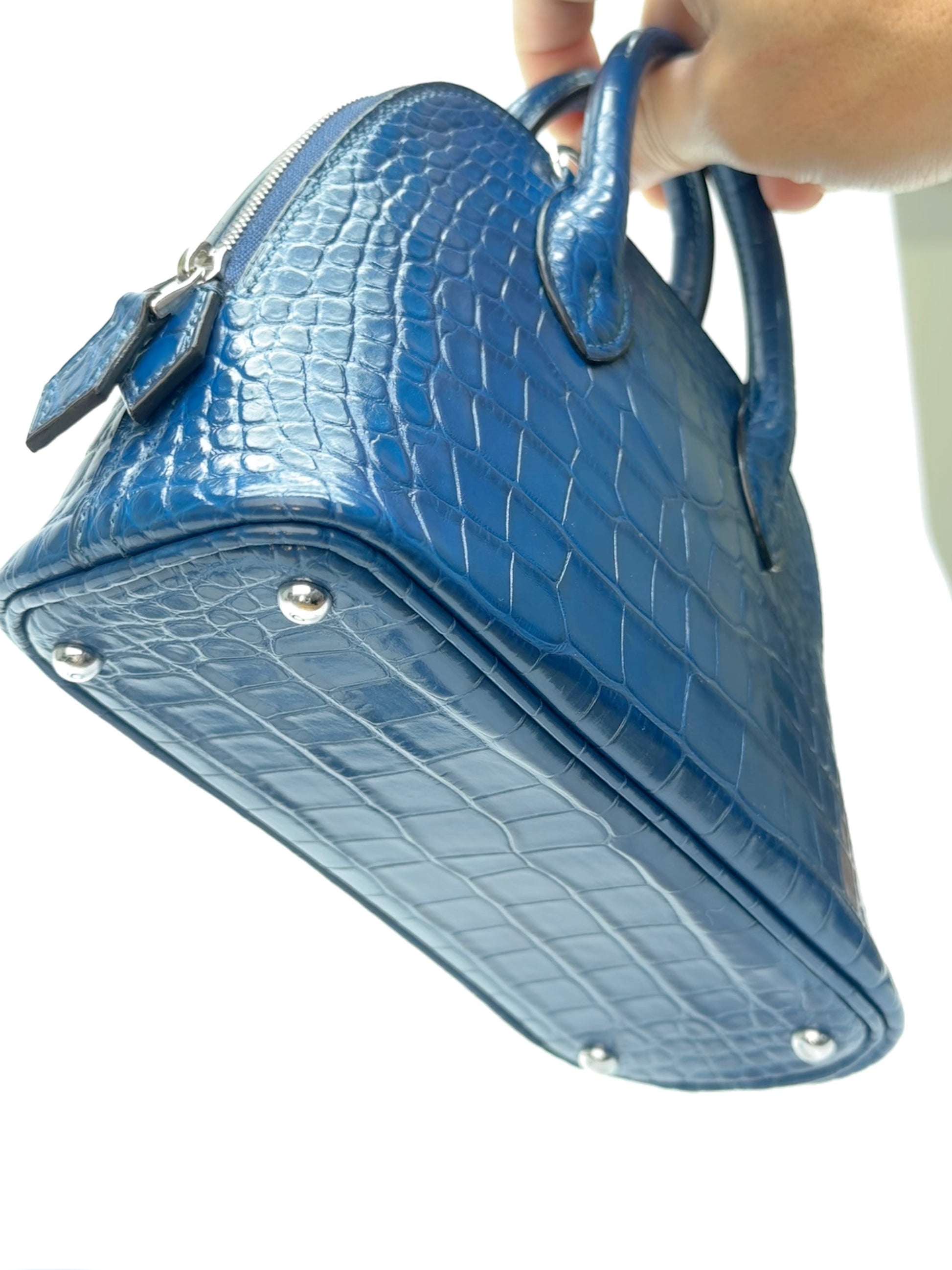 Handle detail of mini dome zip leather bag