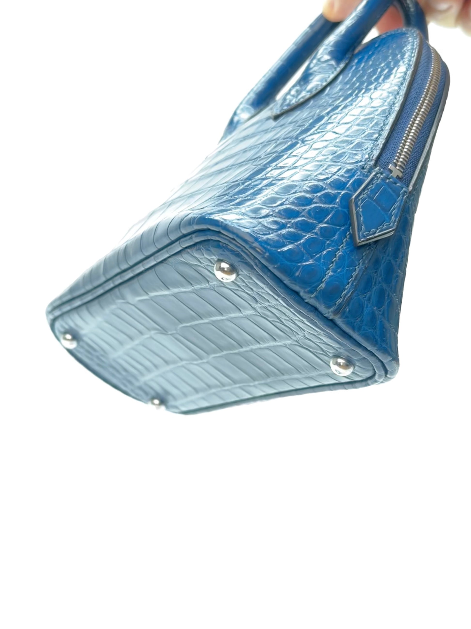 Side gusset detail of dome-shaped leather handbag