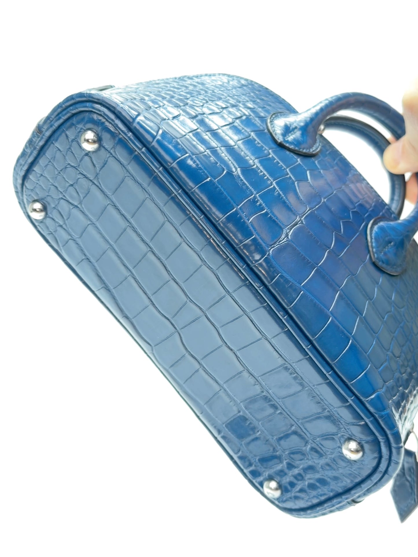 Side view of mini dome zip top-handle leather bag