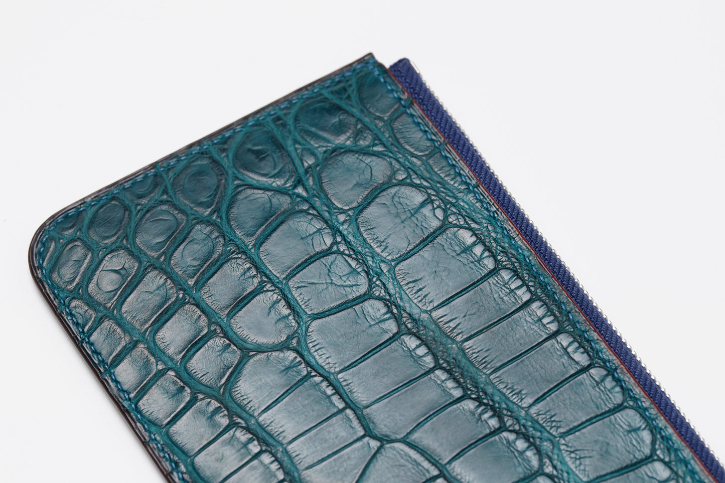 Diagonal detail of crocodile colvert zip wallet