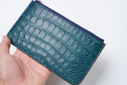 Handmade crocodile colvert zip wallet held in hand