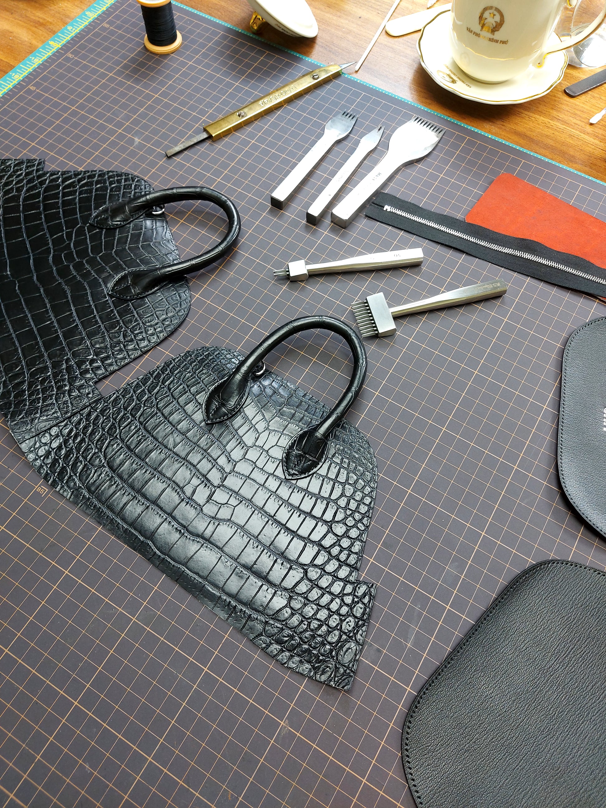 Leathercraft tools and cut pieces for mini dome bag assembly
